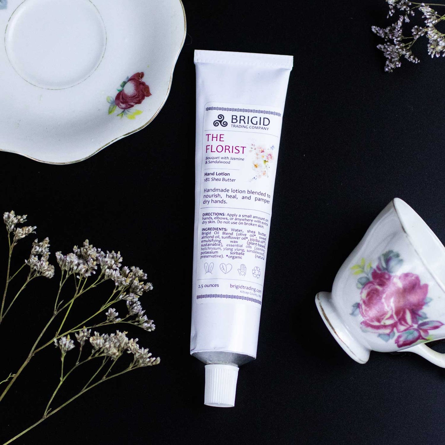Natural hand lotion tube, white with purple logo and front label; capped nozzle