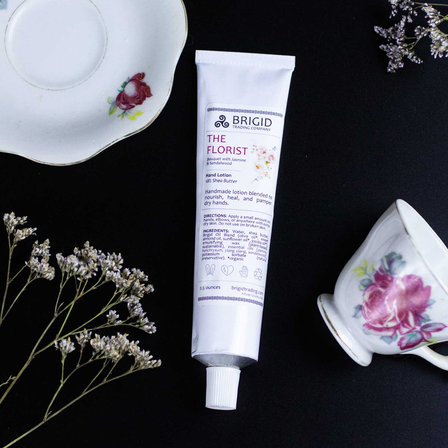 Natural hand lotion tube, white with purple logo and front label; capped nozzle
