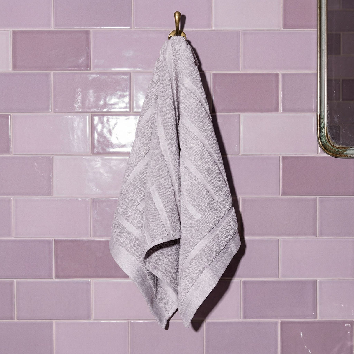 Lilac cotton hand towel hanging with stitched edge