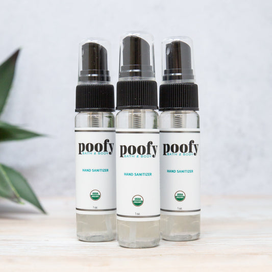 Travel hand sanitizer 3-pack: three clear bottles with black spray caps, Poofy Path & Body