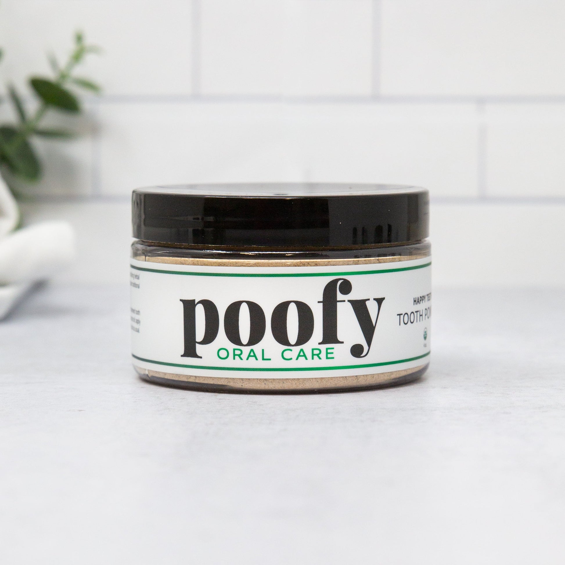 Tooth powder jar with black lid, white label, Poofy Oral Care branding