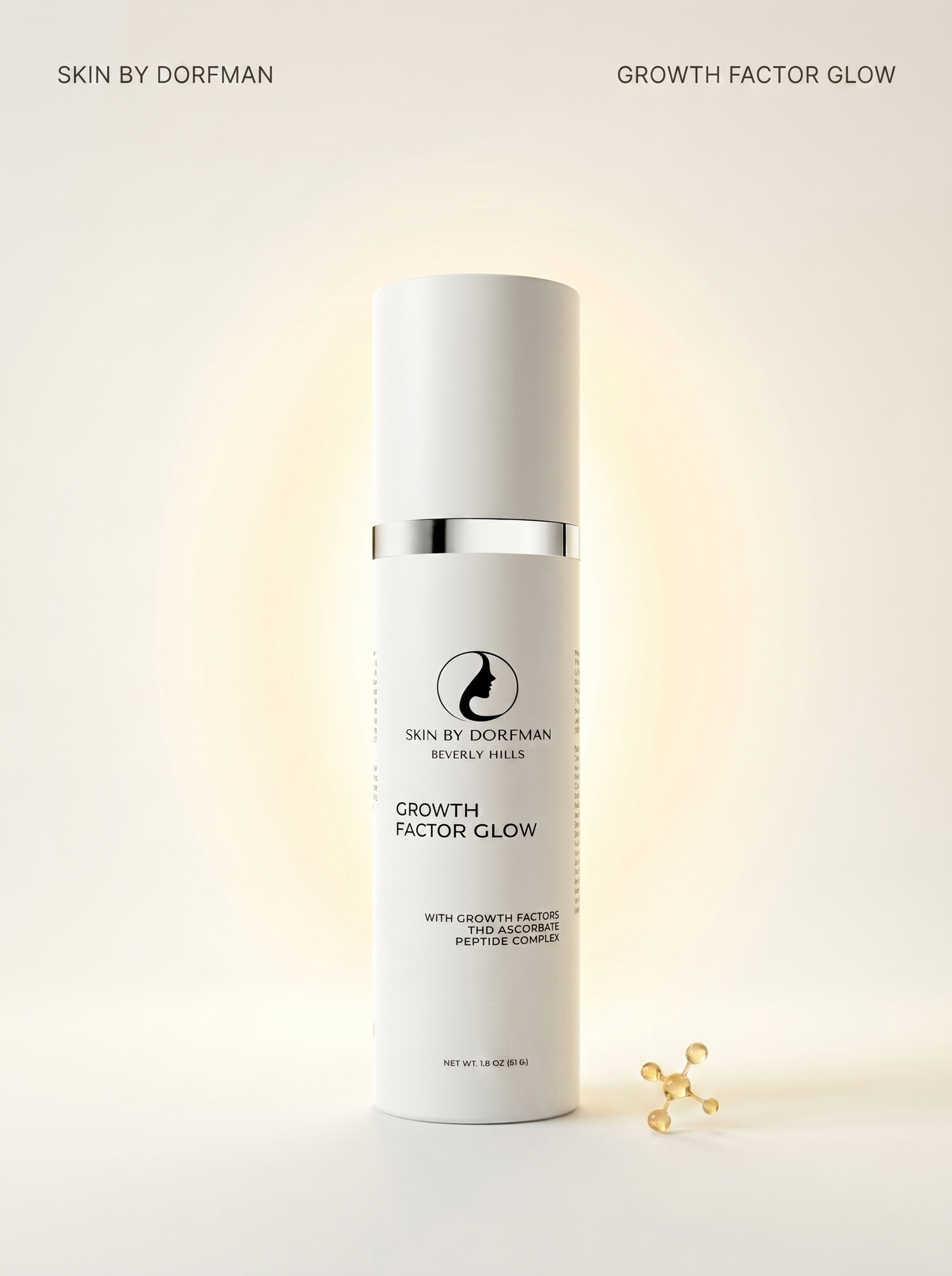 Facial serum bottle on a light surface with small gold charms