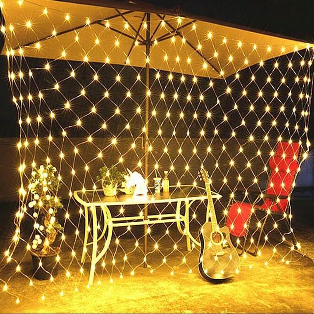 Net mesh solar fairy lights with warm white glow draped overhead