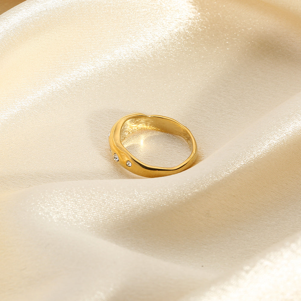Gold snake-shape ring with clear stones, side profile view
