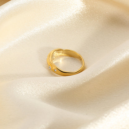 Gold snake-shape ring with clear stones, side profile view