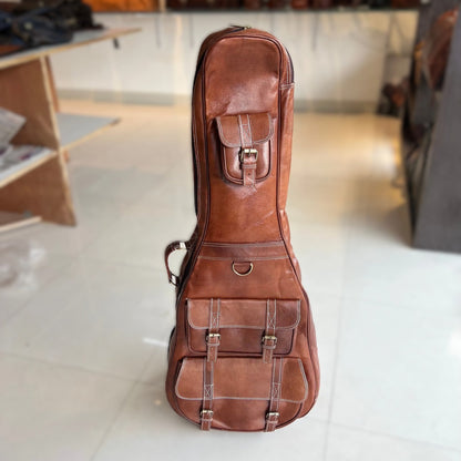 Brown leather guitar case, front view with clasp and padded exterior pockets