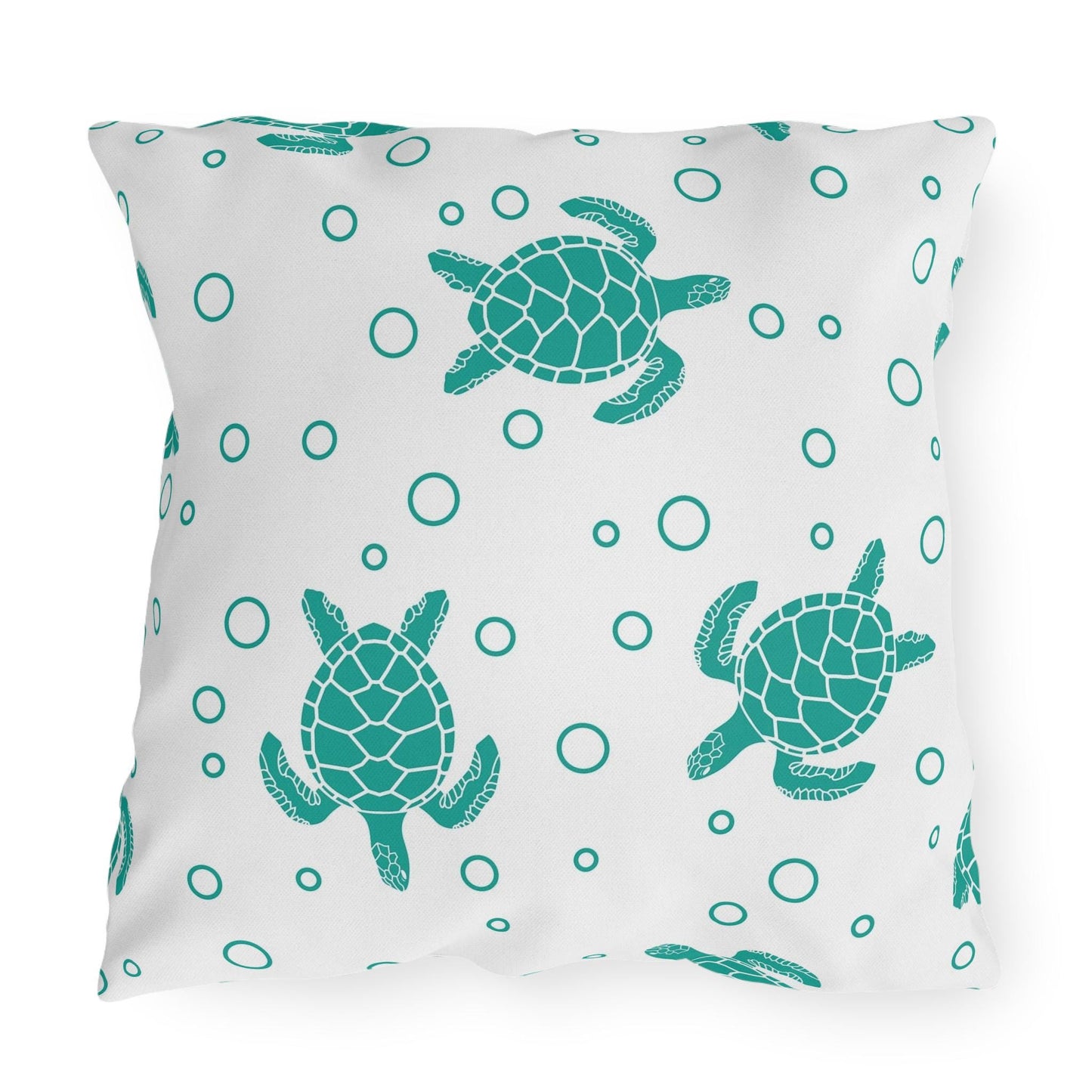 Sea turtle outdoor pillow featuring large centered teal turtle and scattered bubble dots