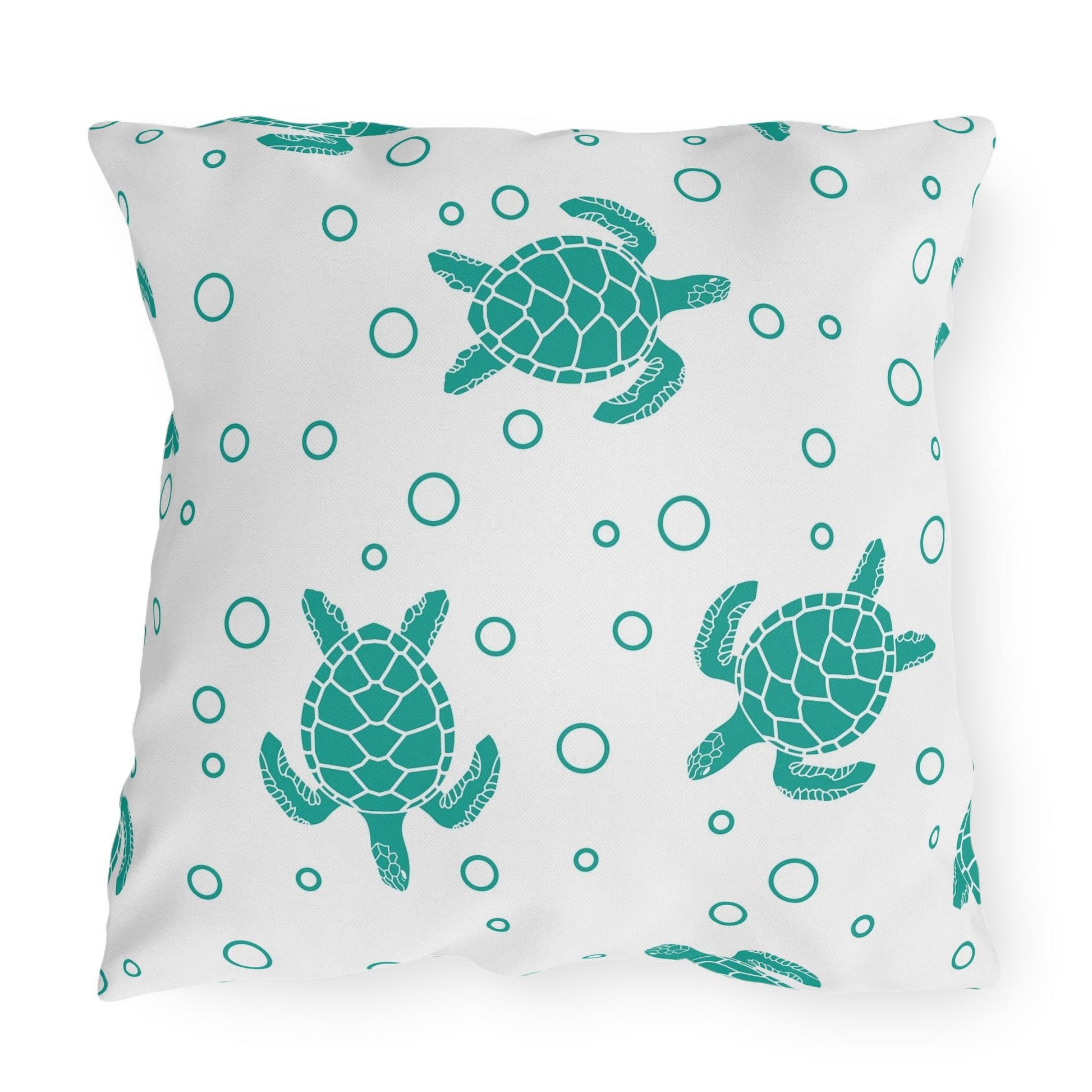 Sea turtle outdoor pillow featuring large centered teal turtle and scattered bubble dots