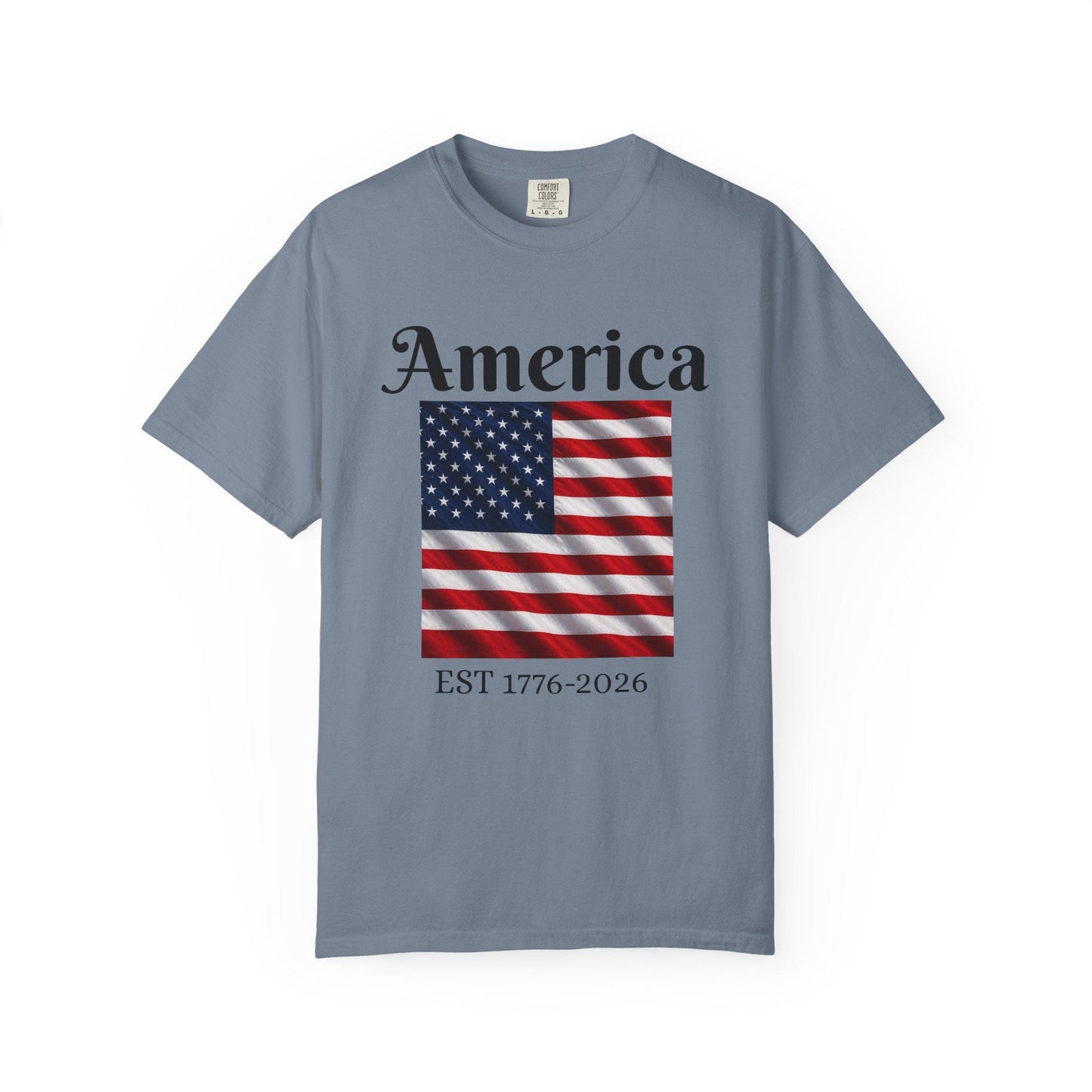 Slate blue T-shirt with America text and American flag graphic, EST 1776-2026