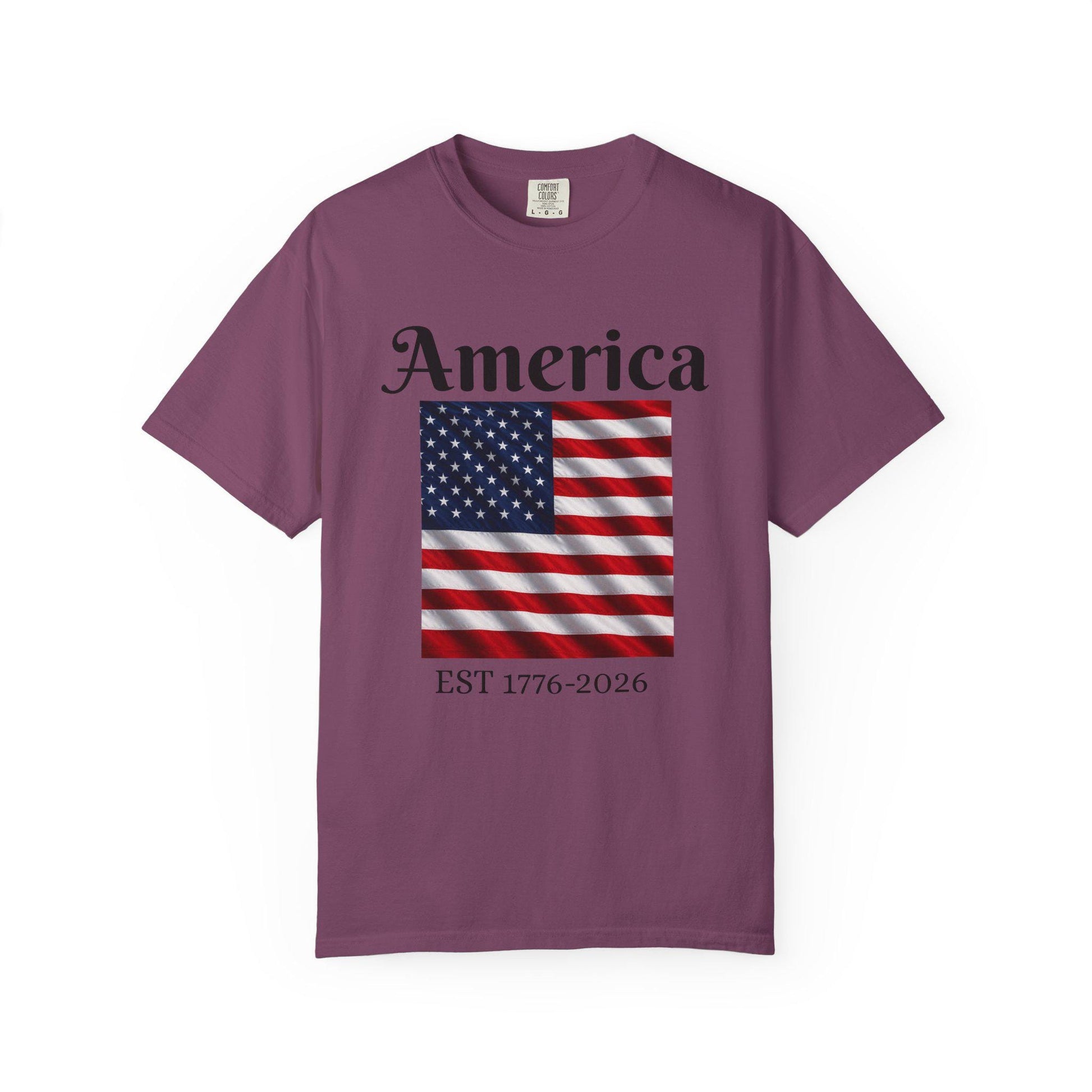Dark plum t-shirt with America text, American flag, and EST 1776-2026