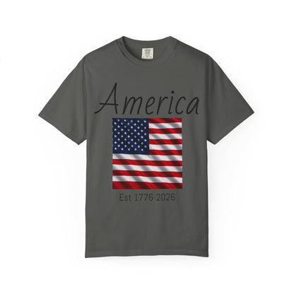 Dark gray T-shirt with 'America' script, U.S. flag graphic, and 'Est 1776-2026'