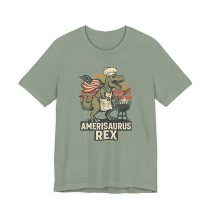 Sage green graphic dinosaur T-shirt with grill, text 'Amerisaurus Rex'.