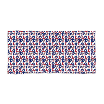 Beach towel with repeating blue, white, and red LOL pattern, visible stitched edging