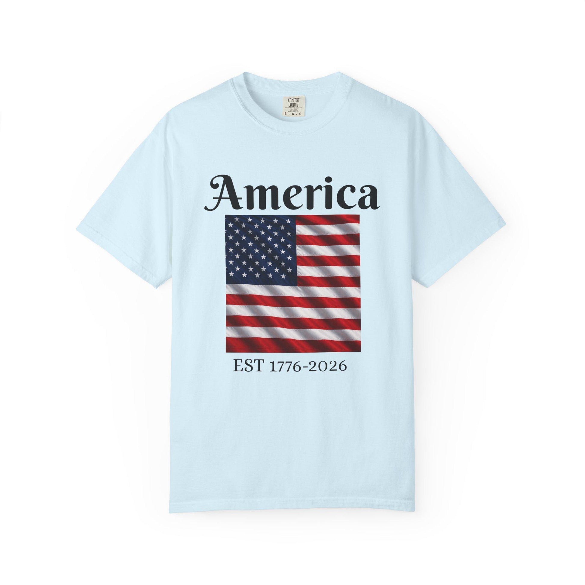 Light blue T-shirt with America text and American flag graphic, EST 1776-2026