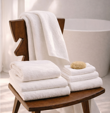 White cotton towels, plush terry, stacked on a bath rack