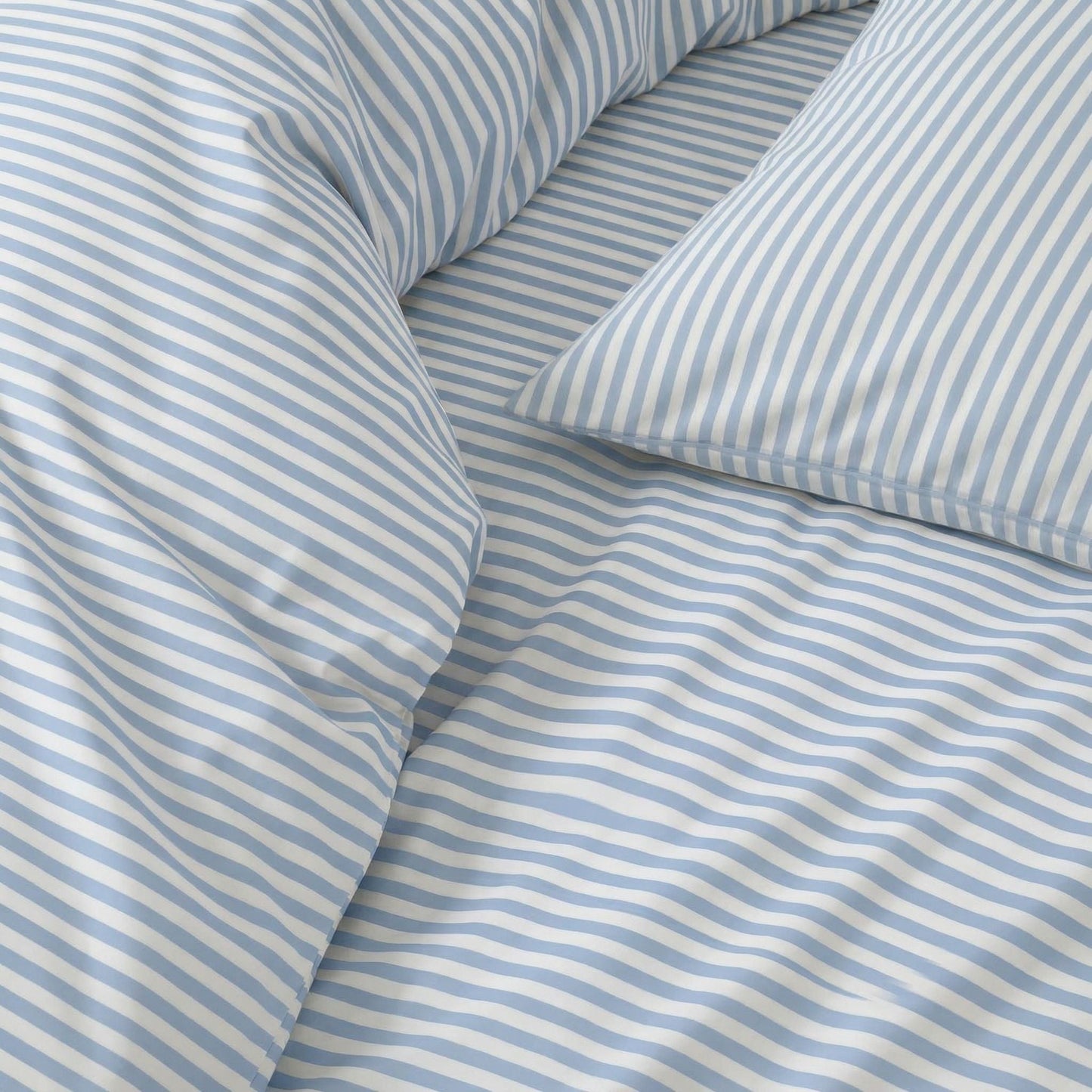Blue and white striped sateen fabric with visible seam and folded creases