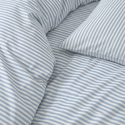 Blue and white striped sateen fabric with visible seam and folded creases