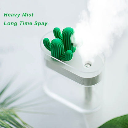 White ultrasonic humidifier with green cactus top, heavy mist rising from the nozzle