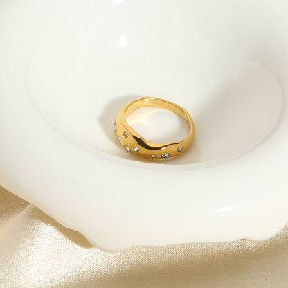 Gold snake-shape ring with clear stones, centered top view