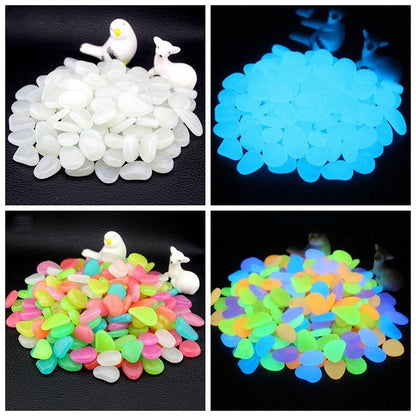 Glow-in-the-dark garden pebbles with white and blue glowing piles on black