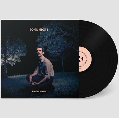 Vinyl record and album sleeve showing dark blue night cover art