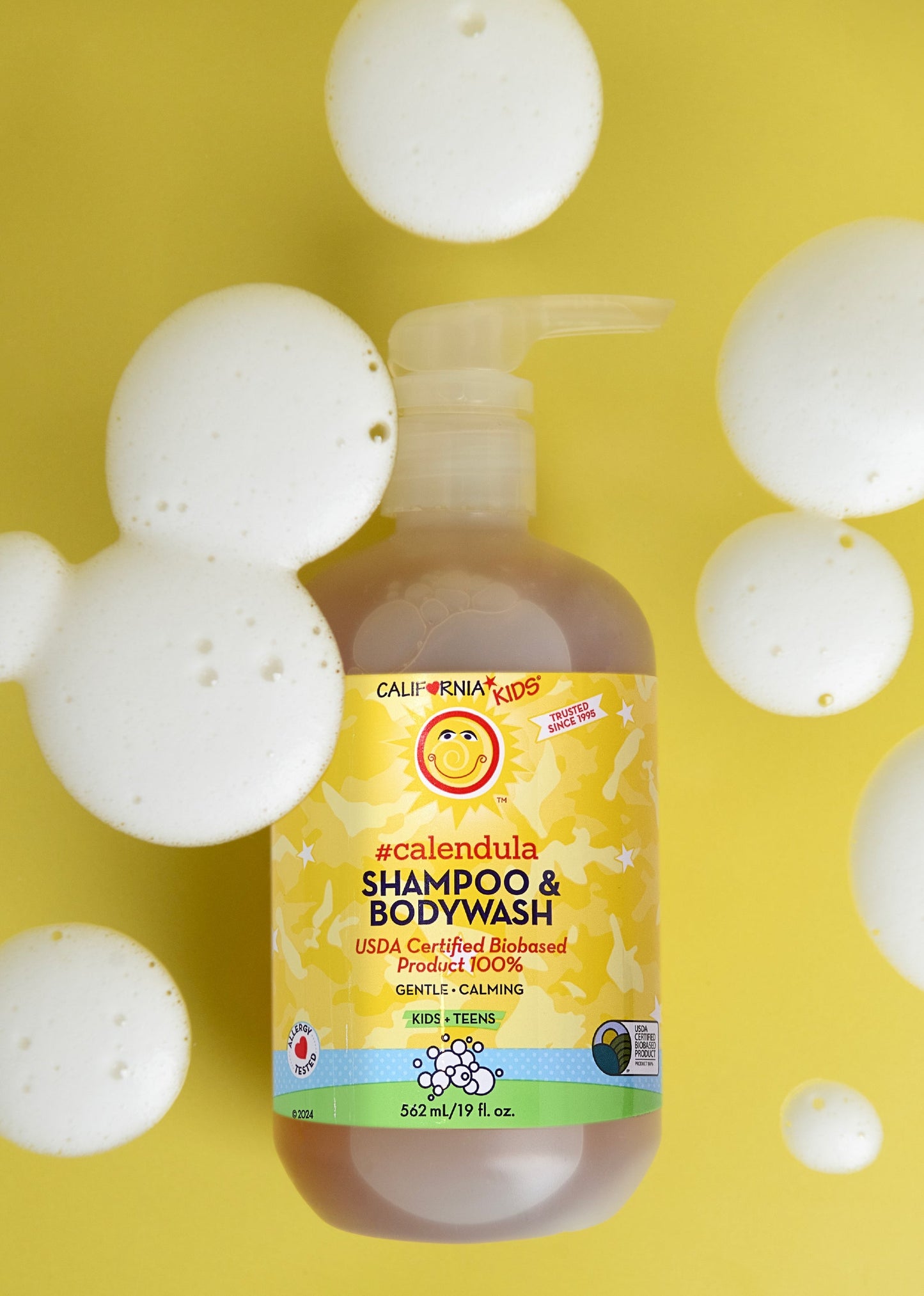 Kids Calendula shampoo & bodywash bottle with foam bubbles, yellow label