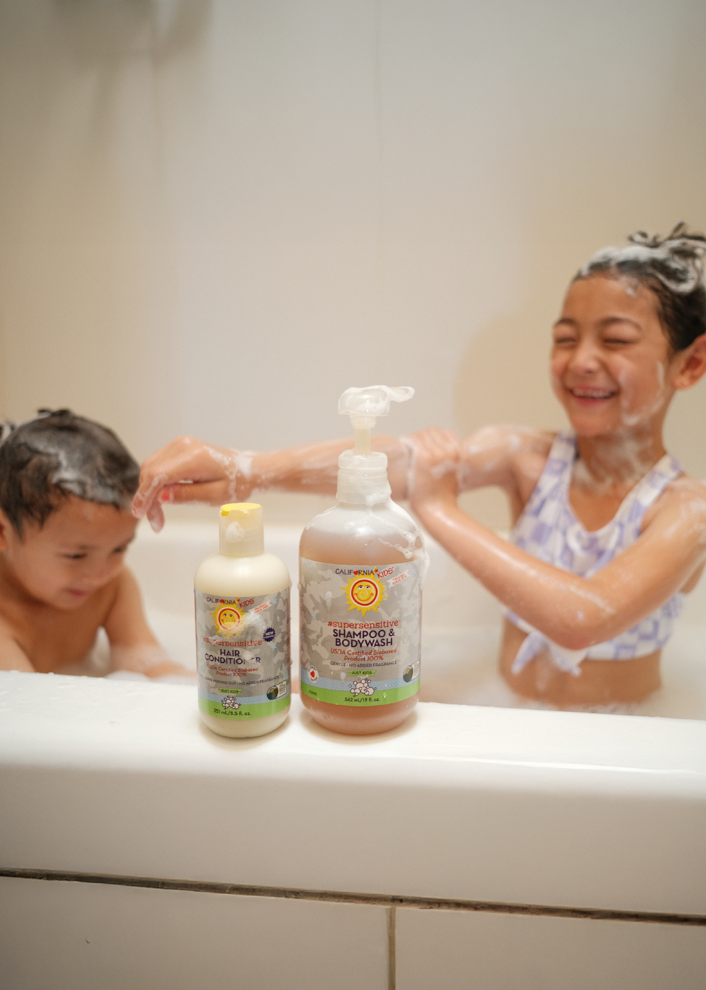 Kids supersensitive body wash and shampoo bottles with pump and conditioner bottle in bath
