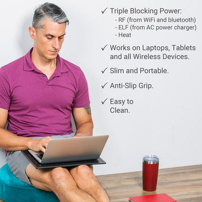Black laptop pad with anti-slip grip, supporting a laptop on a person’s lap.