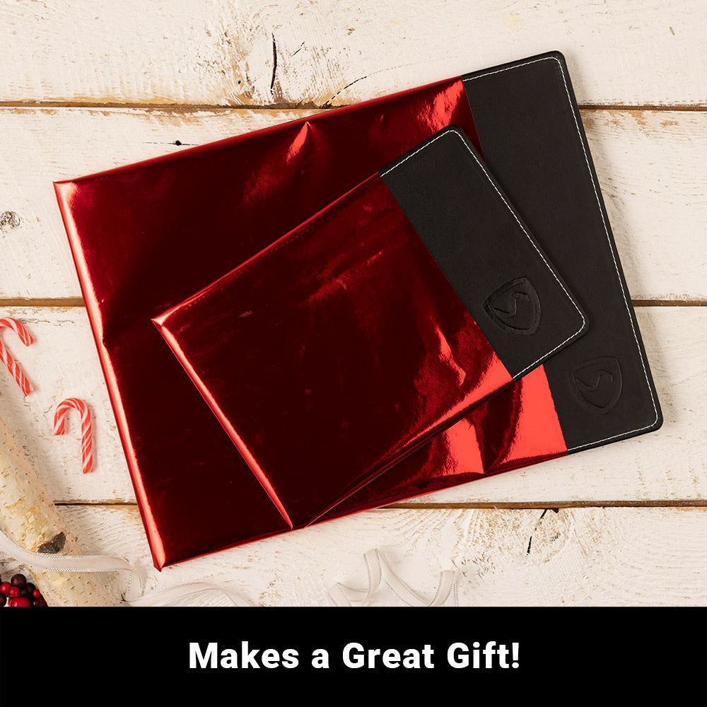 Black laptop pad in a red gift box, with two molded compartments visible.