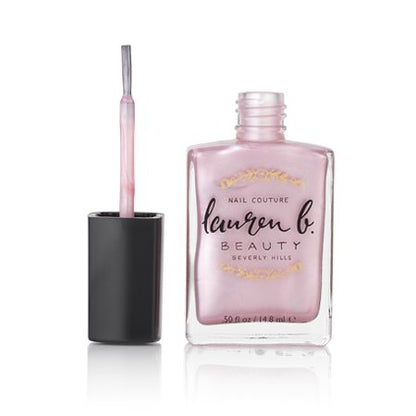 Pink nail polish bottle with black cap and attached brush applicator