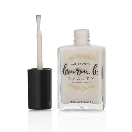 Champagne nail polish bottle with brush applicator, black cap
