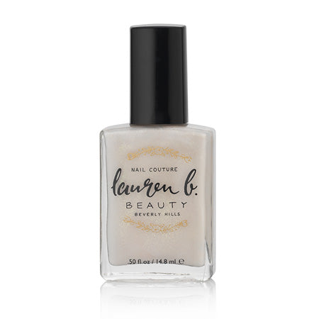 Champagne-colored vegan nail polish bottle with black cap, 0.5 fl oz