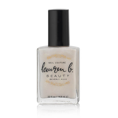 Champagne-colored vegan nail polish bottle with black cap, 0.5 fl oz