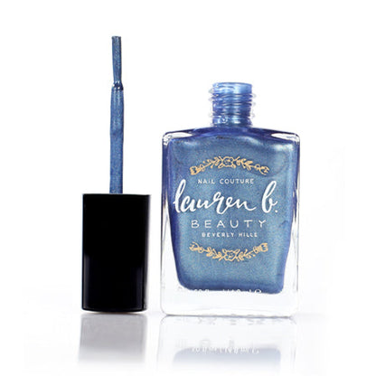 Blue glitter nail polish bottle with brush showing liquid