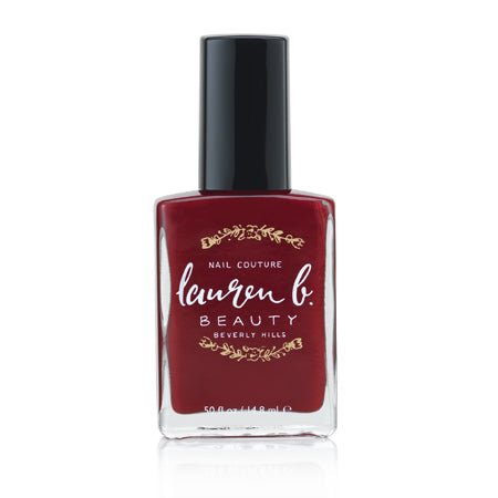 Burgundy vegan nail polish bottle with black cap, glossy finish.