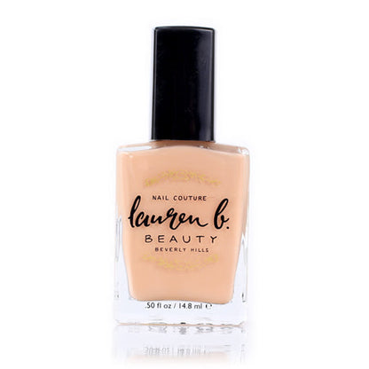 Nail base coat bottle with nude peach liquid and black cap.