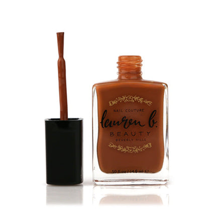 Nail polish bottle with brush applicator in warm bronze-brown