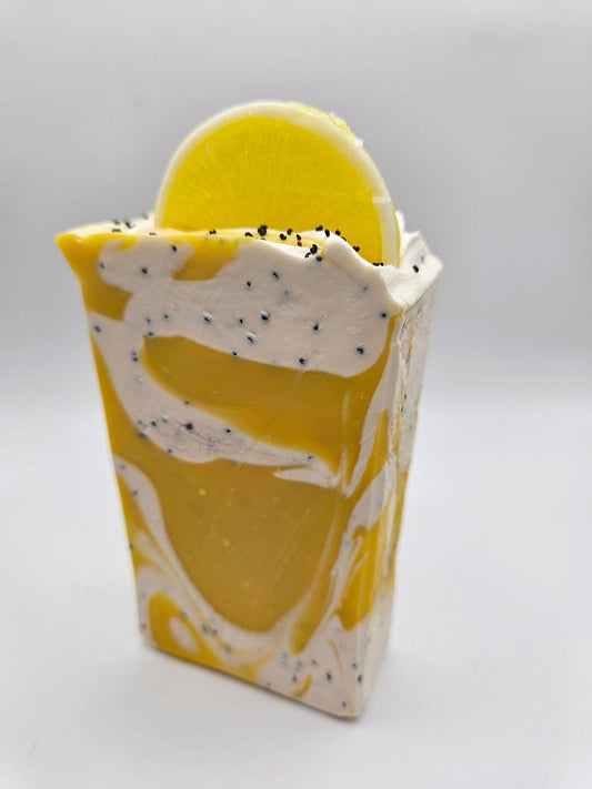 Lemoncello artisan soap bar with yellow lemon swirl on a white base and black speckles