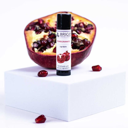 Pomegranate lip balm tube with black cap and branding label