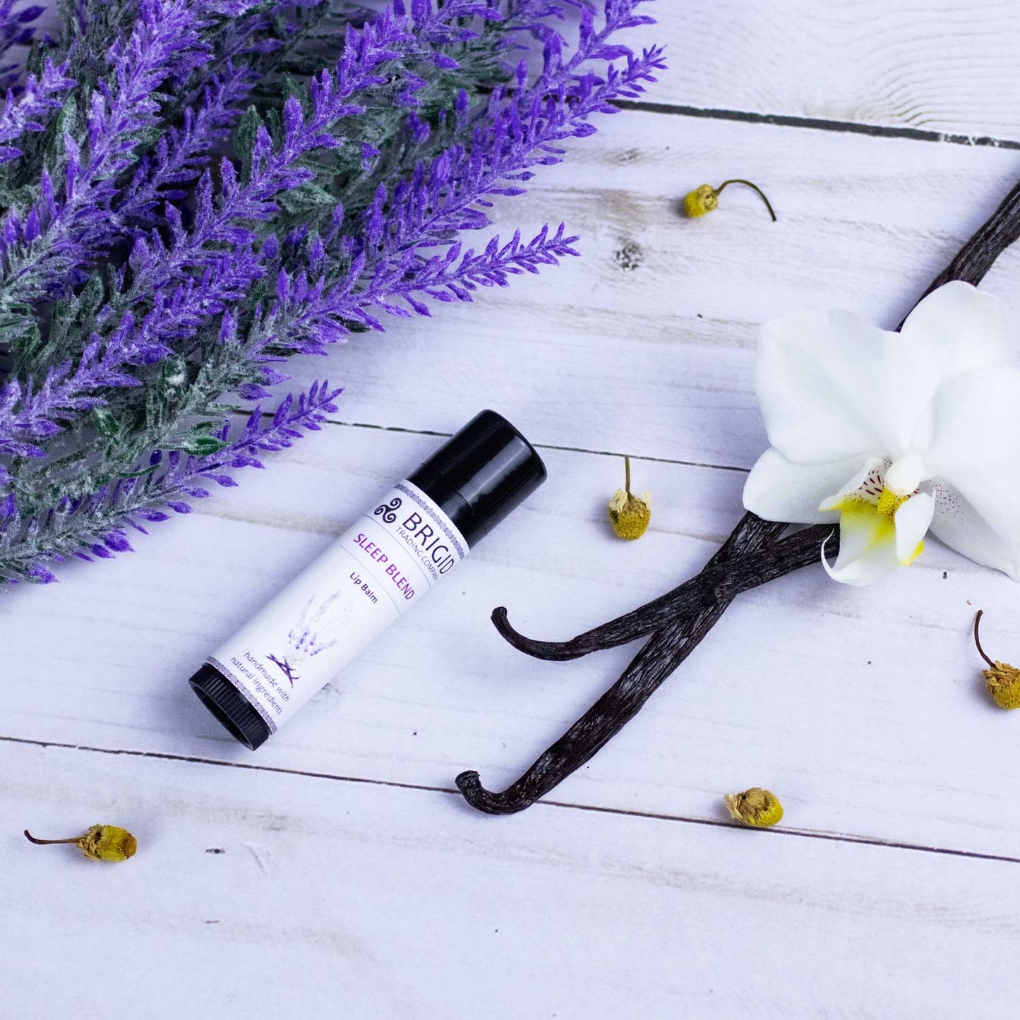 Natural lip balm tube with black cap and BRIGID label