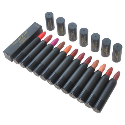 Lip crayon balm pencils in assorted shades arranged in a row with box