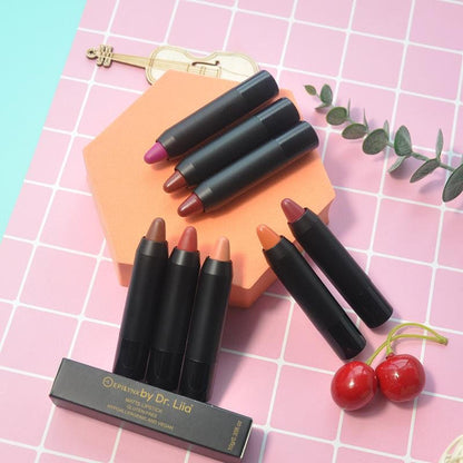Set of lip crayon balm pencils in assorted shades with display box on tile