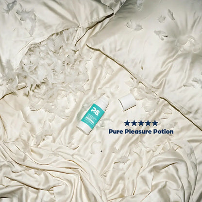 Teal-and-white personal lubricant bottle and cap on crinkled white wrap