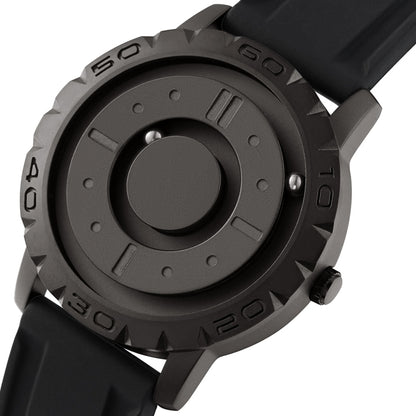 Men’s magnetic pointer watch with dark face and black bezel, showing central dial detail