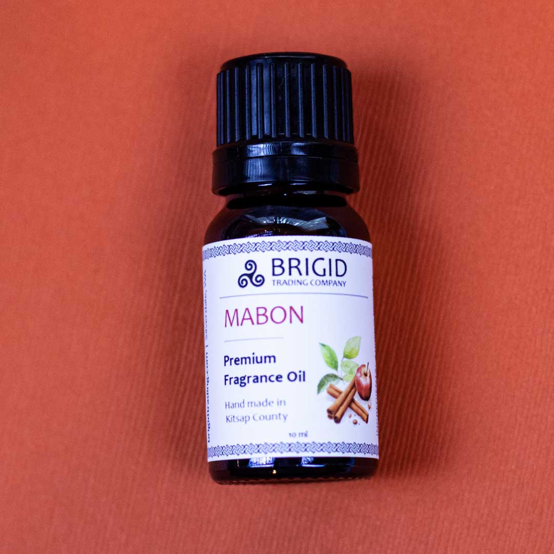Diffuser oil bottle with black cap and labeled front view on a solid pink background