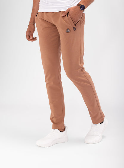 Rust brown tapered athletic sweatpants with drawstring waist and side pockets