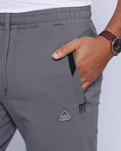 Men's athletic sweatpants, grey with elastic waistband, drawstring, and side logo patch
