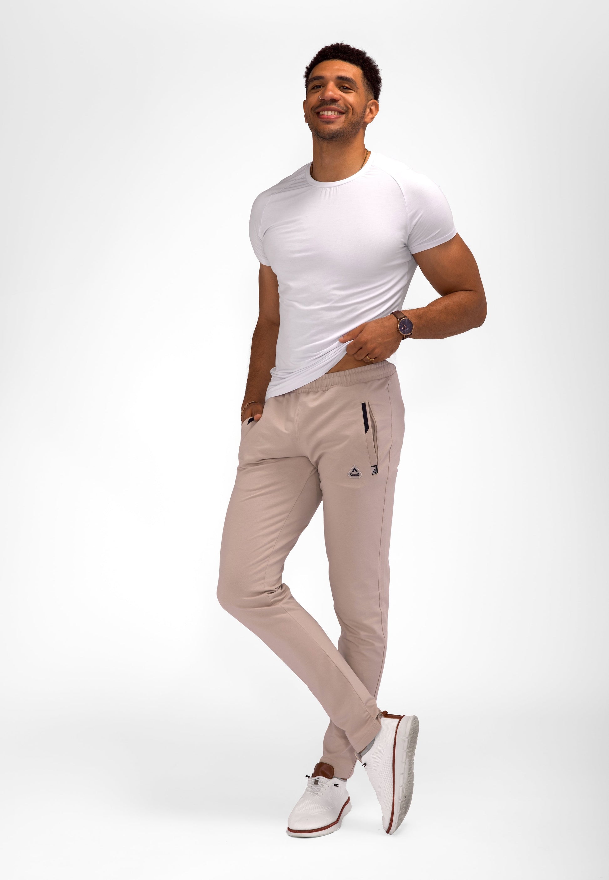 Athletic sweatpants with tapered legs, elastic waistband, and drawstring; light khaki color.