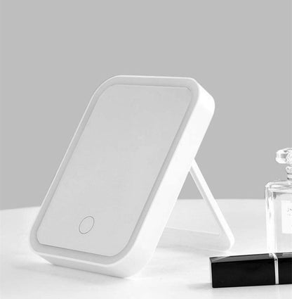 White freestanding makeup mirror with LED light border and round power button