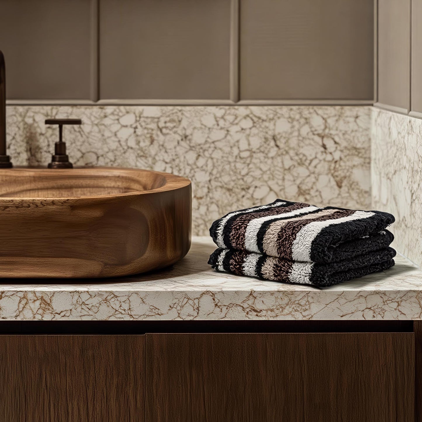 Black and cream striped cotton towels, folded stack